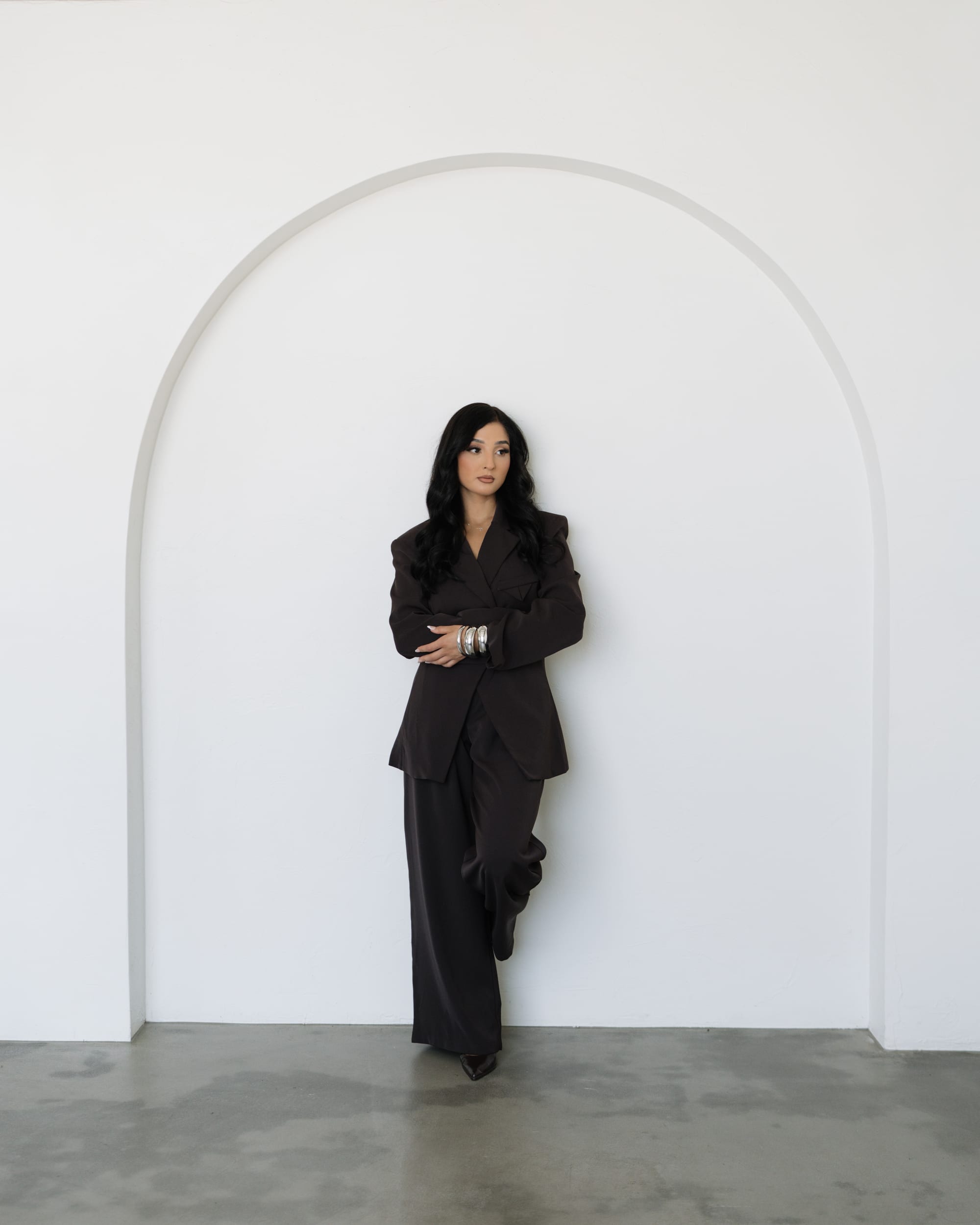 Elizabeth Valdovinos standing inside a circular studio arch